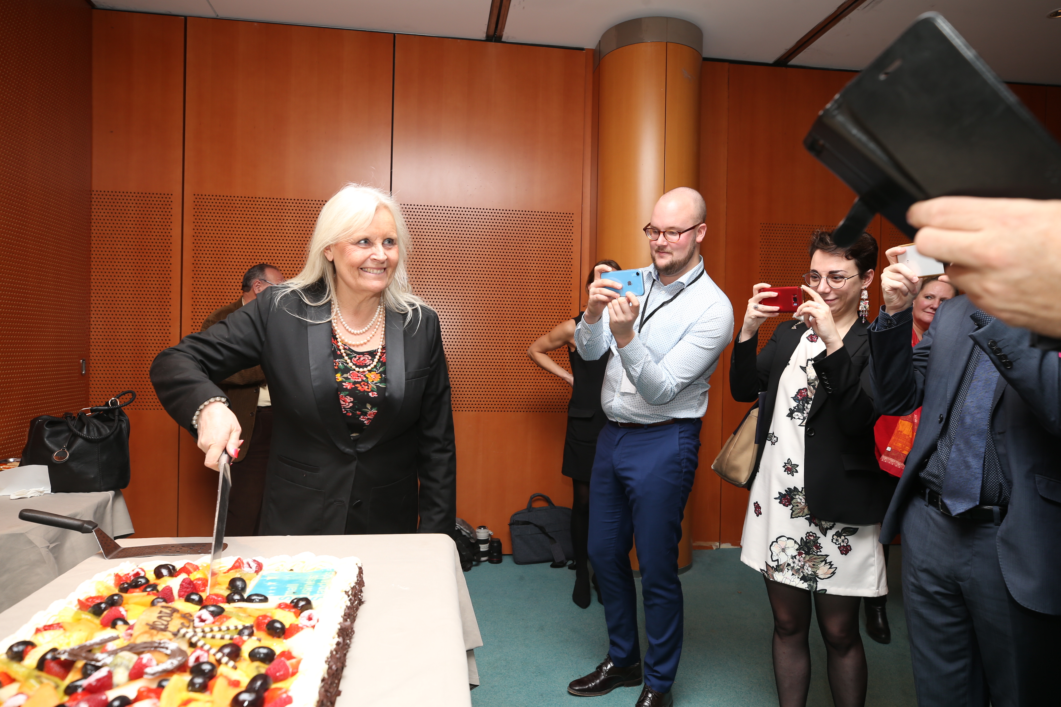 SBS president cutting a cake